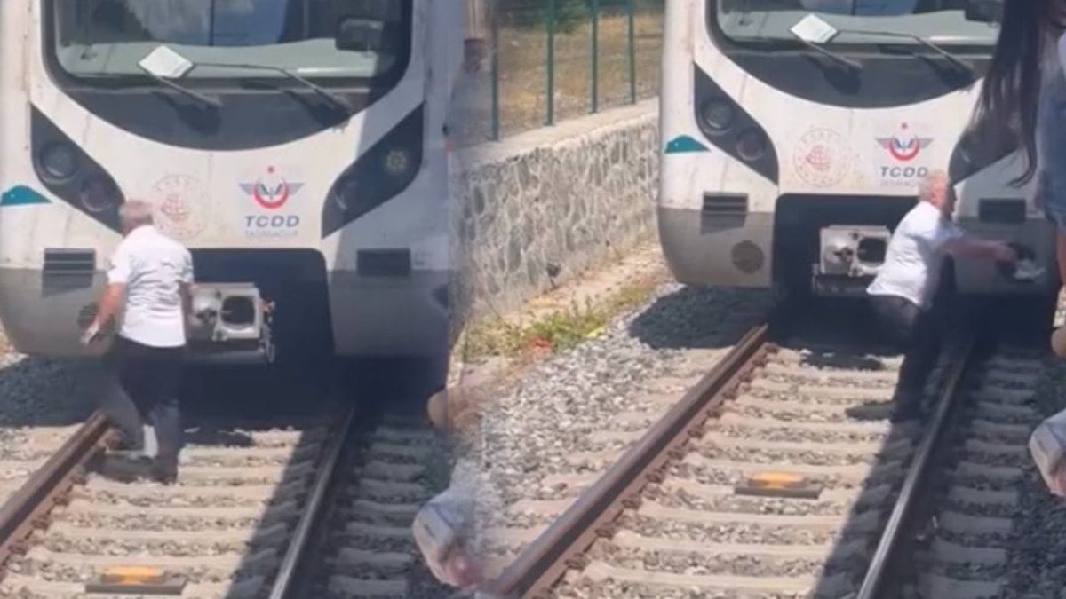 Raylara düşen kediyi kurtarmak için treni durdurdu, raylara indi Raylara düşen kediyi kurtarmak için treni durdurdu, raylara indi